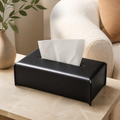 Black leather-look tissue box cover on a warm neutral living-room side table
