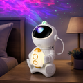 Cozy Haven white astronaut rocket galaxy projector in a softly lit bedroom