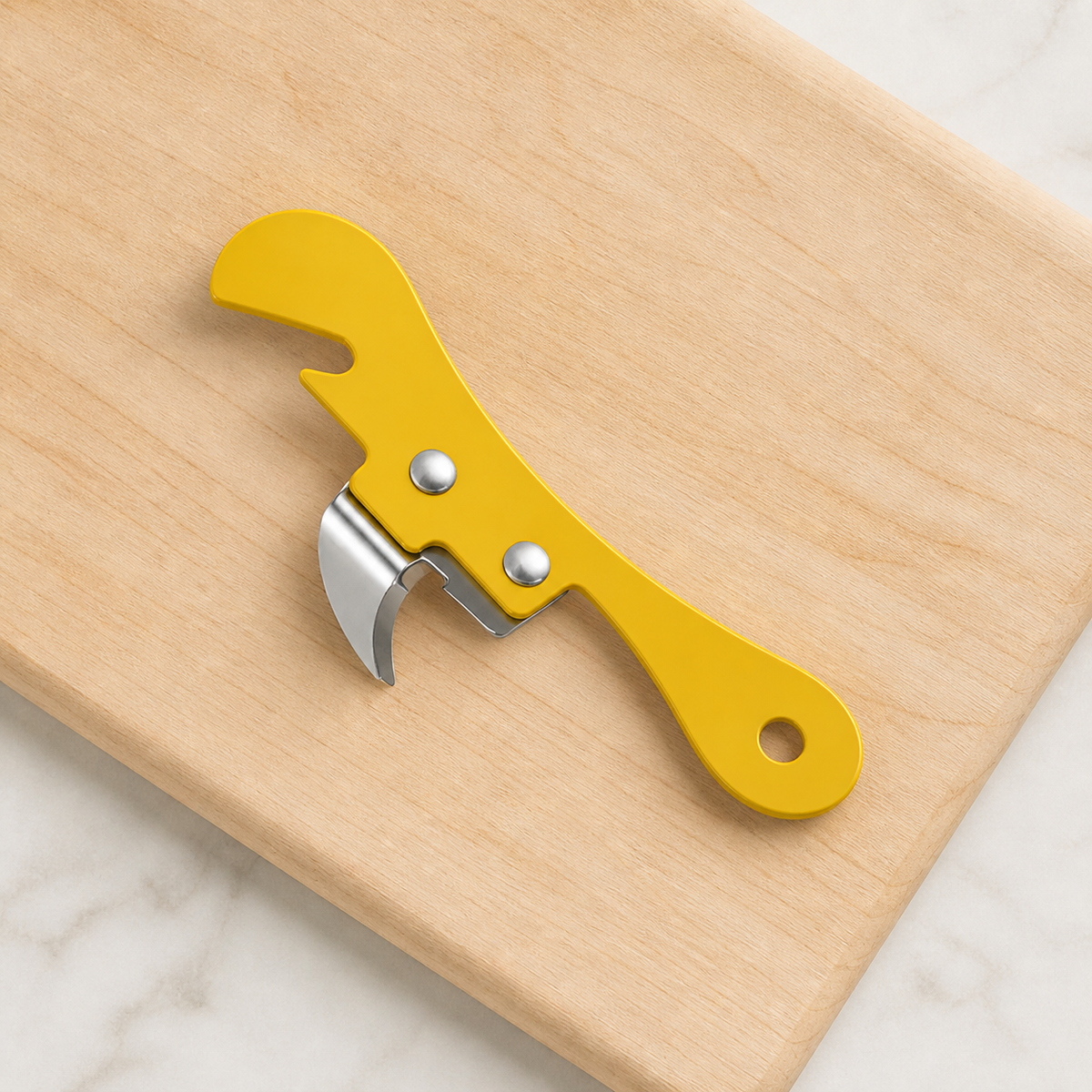 Yellow metal opener with two silver rivets, curved blade, hooked head and hanging hole