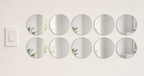 Ten identical 12 cm round acrylic mirror wall stickers beside a light switch