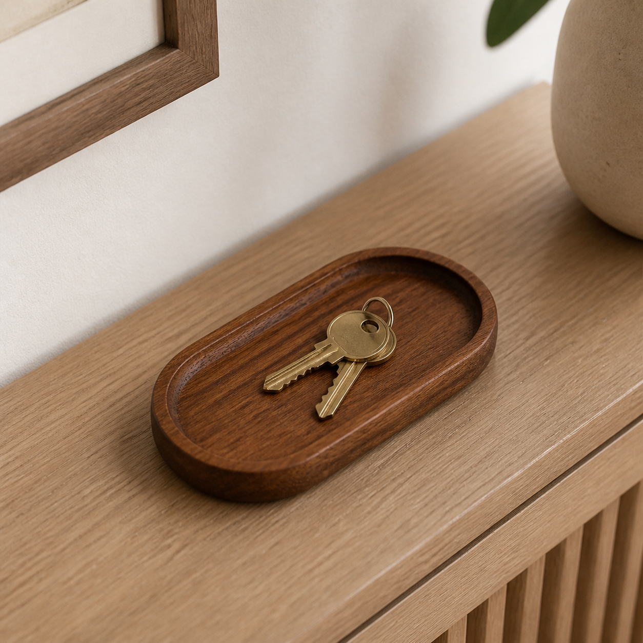 Small 18 x 10 cm plain dark wood tray holding two house keys on an entryway console