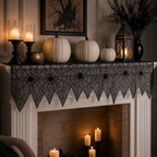 Black spider web table runner on a mantel with Halloween candles and pumpkins