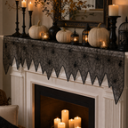 Black spider web table runner across a candlelit Halloween mantel display