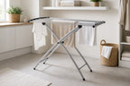 Cozy Haven White Accordion Foldable Drying Rack freestanding X-frame rack with towels in a laundry room
