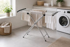 Cozy Haven White Accordion Foldable Drying Rack freestanding rack beside a washer with towels