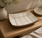 Cream quilted leather-look catchall tray on a bedroom or entry surface