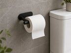 Matte black adhesive paper roll holder shown in a compact bathroom setup
