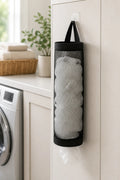 Cozy Haven black wall-mounted grocery bag holder in laundry room