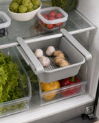 Gray vented under-shelf fridge drawer holding small produce