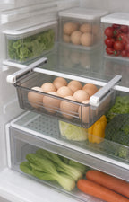 Under-shelf refrigerator drawer holding eggs in a clear tray