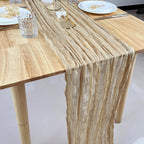 Khaki gauze table runner draped across a dining table
