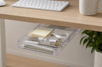 Clear small adhesive under-desk drawer organizer below a desk