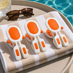 Orange 3-piece beach towel clips on a folded towel