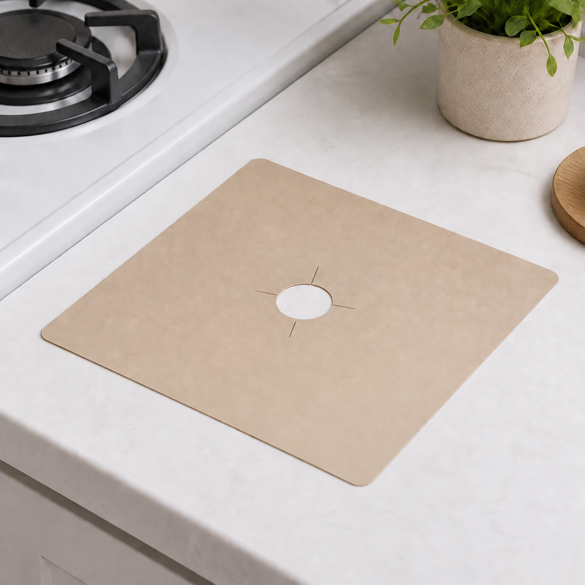 One Beige 27 x 27 cm gas-stove burner liner beside an unlit gas burner in a kitchen