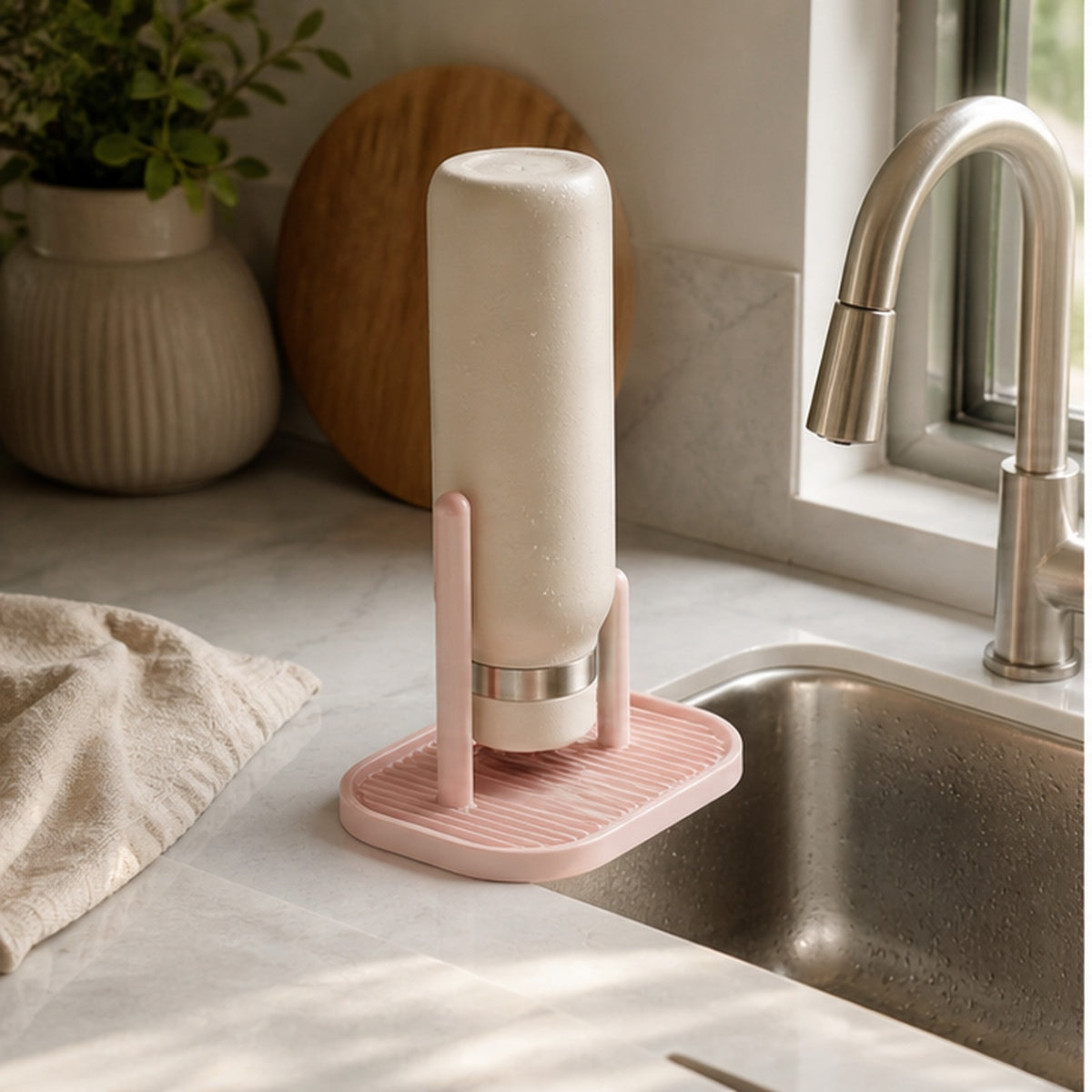 Cozy Haven Blush Silicone Bottle Drying Stand styled in a home setting