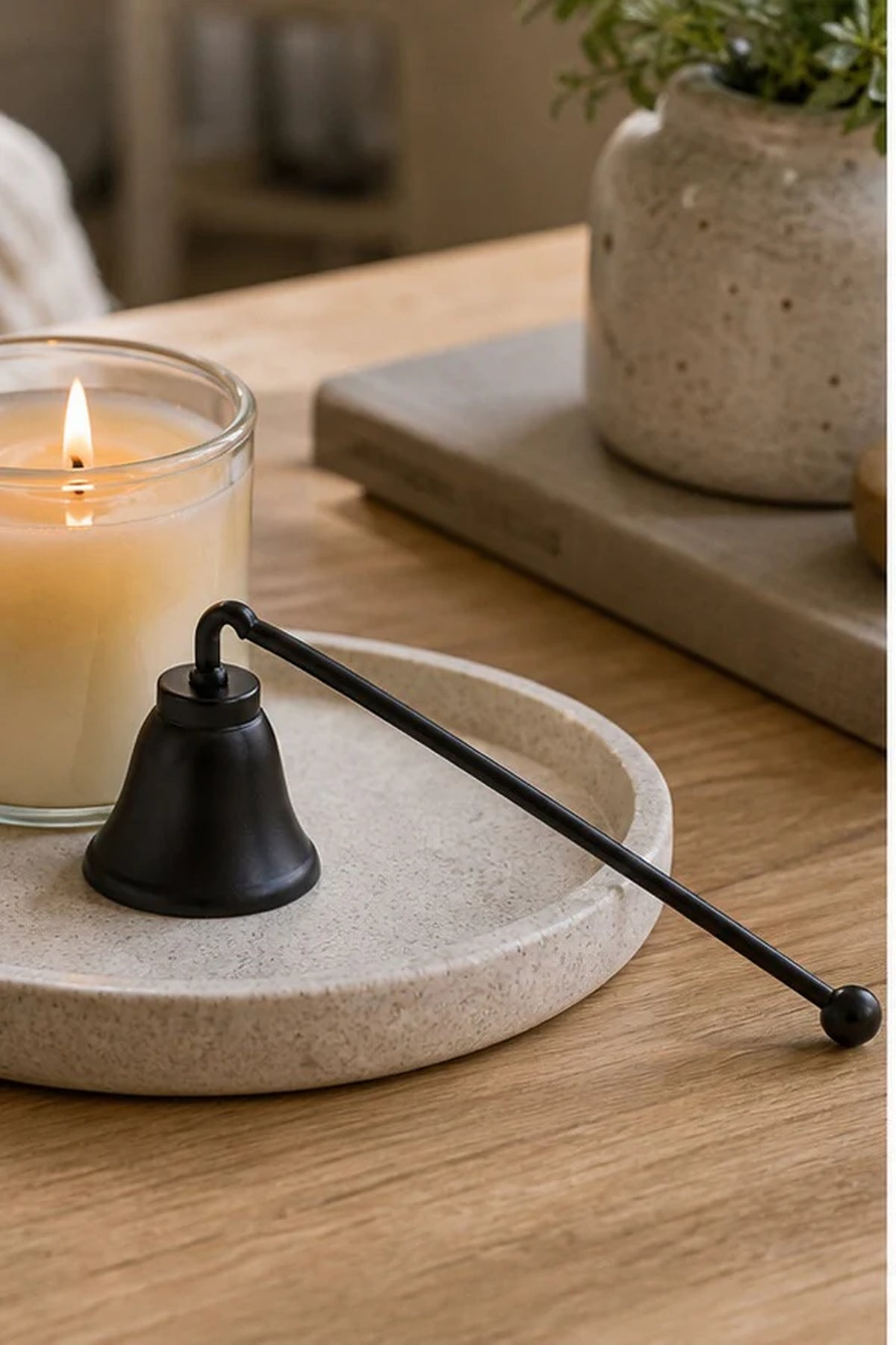 Cozy Haven Black Candle Snuffer styled in a home setting