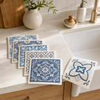 Six blue retro-pattern Swedish dishcloths beside a bright kitchen sink