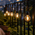 Cozy Haven Globe Solar String Lights on balcony railing