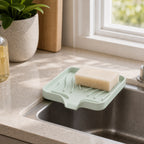 Cozy Haven Self-Draining Sink Caddy in Light Green on a kitchen sink edge