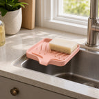 Cozy Haven Self-Draining Sink Caddy in Pink on a kitchen sink edge