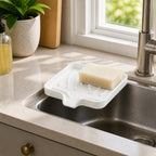 Cozy Haven Self-Draining Sink Caddy in White on a kitchen sink edge