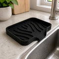 Cozy Haven black self-draining sink caddy on kitchen sink edge