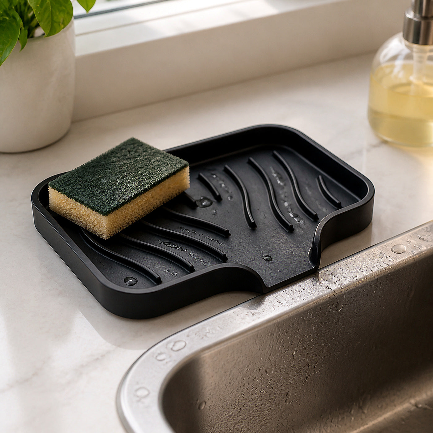 Cozy Haven black self-draining sink caddy draining water beside kitchen sink
