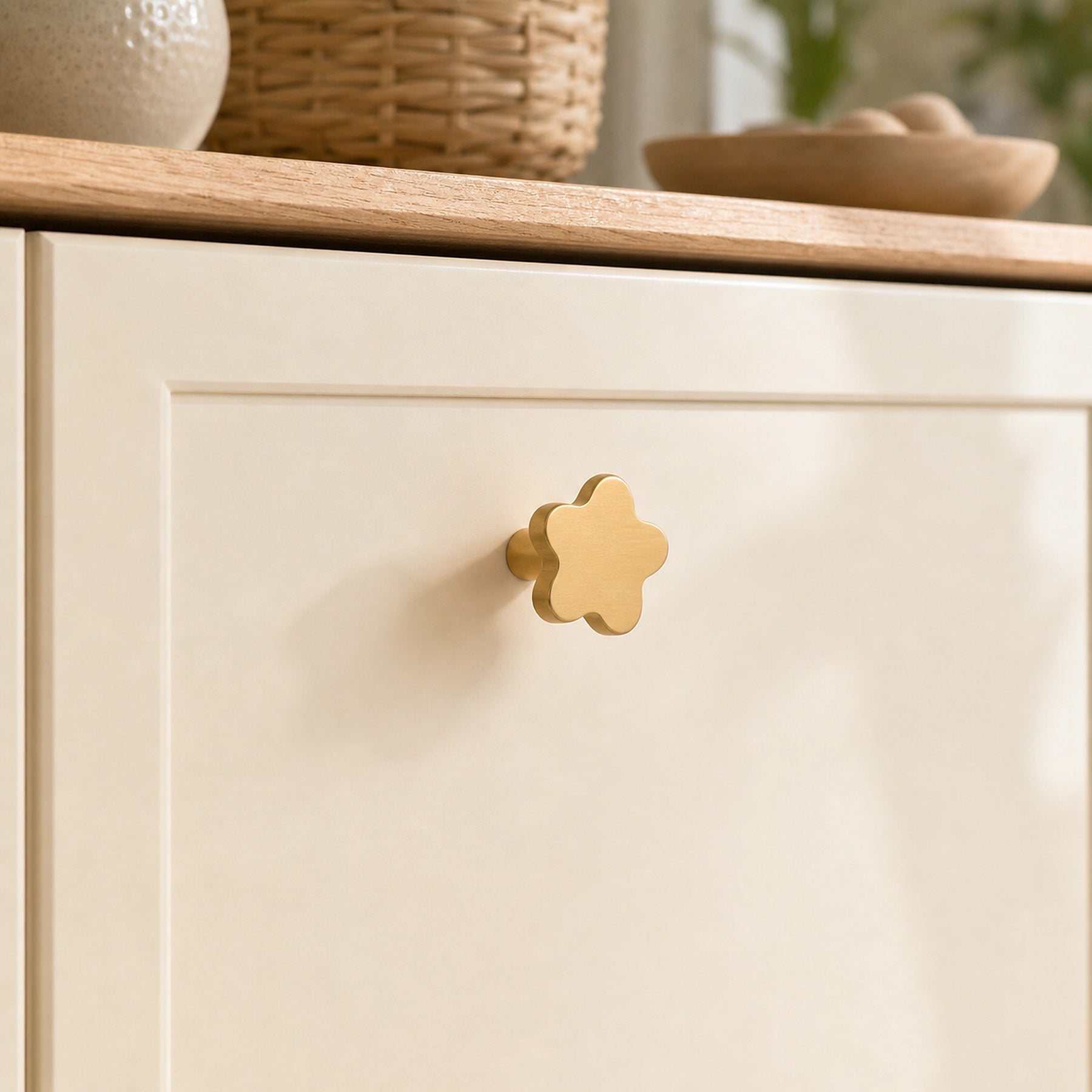 Cozy Haven Gold Flower Cabinet Knob installed on a white drawer