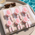 Pink 6-piece beach towel clips on a folded towel