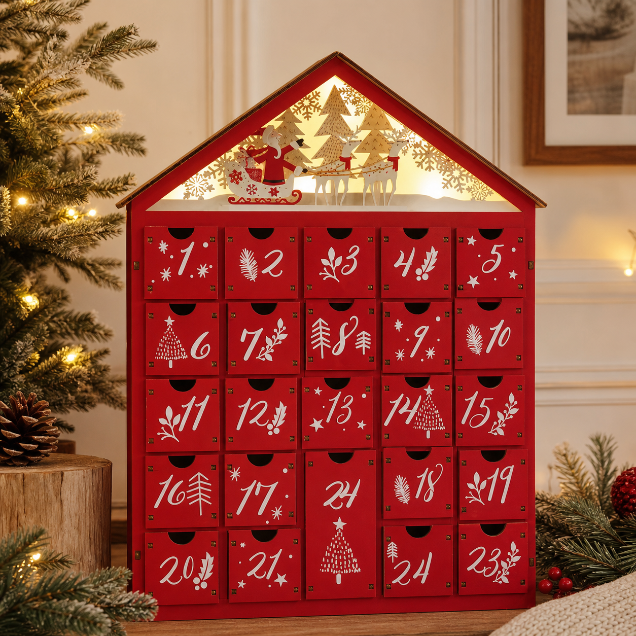 Red wooden house-shaped advent calendar with 24 drawers on a holiday mantel