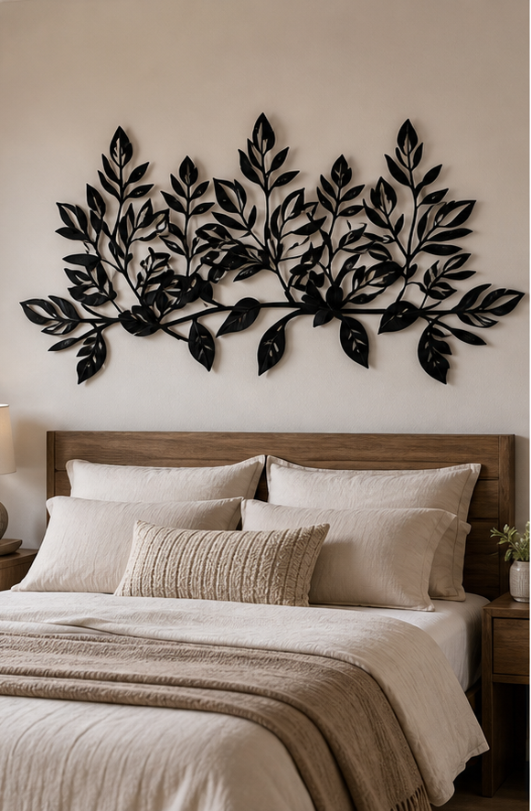 The leaf branch mounted above a console table with a lamp and vase beneath