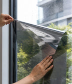 Silver reflective window privacy film styled on a bright home window