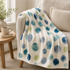 Cozy Haven Watercolor Dot Throw Blanket on an armchair with soft dotted pattern