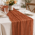 Terracotta crinkled gauze table runner styled on a set table